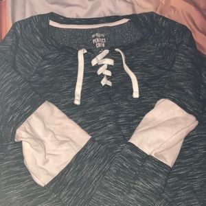 Dark gray sweater with a pink strip on each arm